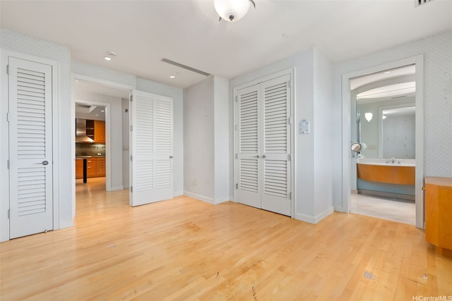 1740 S Beretania St Unit 10, Honolulu, HI 96826 - unfurnished bedroom with light wood finished floors, baseboards, recessed lighting, and ensuite bathroom