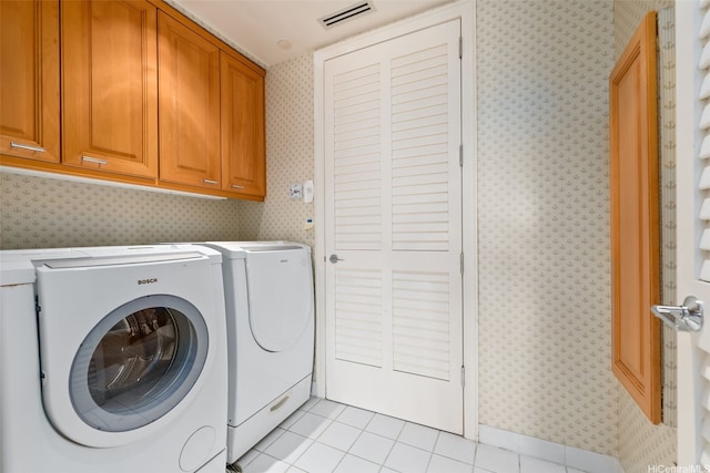1740 S Beretania St Unit 10, Honolulu, HI 96826 - laundry area featuring wallpapered walls, washing machine and clothes dryer, cabinet space, and light tile patterned floors