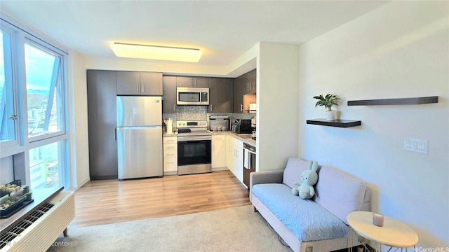 988 Halekauwila St Unit 1801, Honolulu, HI 96814 - kitchen featuring appliances with stainless steel finishes, tasteful backsplash, plenty of natural light, and light countertops