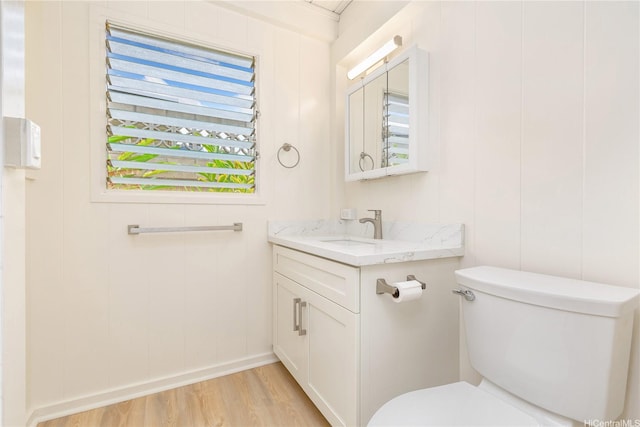 1645 Palamoi St, Pearl City, HI 96782 - bathroom featuring wood finished floors, vanity, toilet, a decorative wall, and baseboards