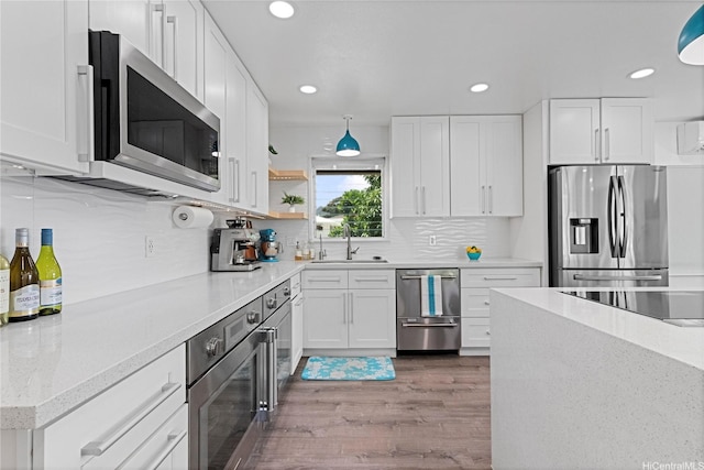 465A Kawailoa Rd, Kailua, HI 96734 - kitchen featuring stainless steel appliances, a sink, recessed lighting, wood finished floors, and white cabinetry