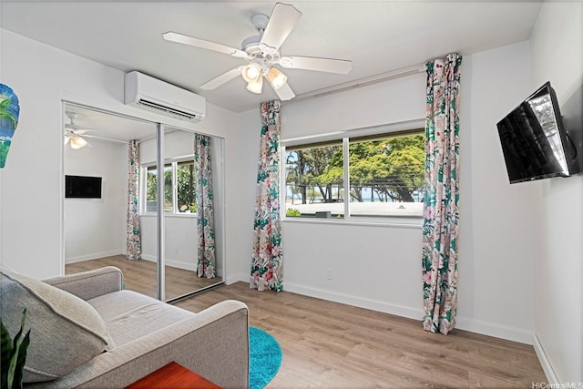 465A Kawailoa Rd, Kailua, HI 96734 - sitting room with a wall unit AC, ceiling fan, wood finished floors, and baseboards