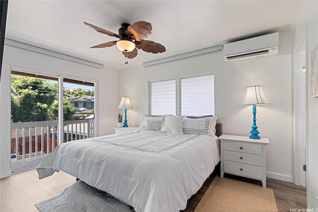 465A Kawailoa Rd, Kailua, HI 96734 - bedroom with a wall mounted air conditioner, access to exterior, wood finished floors, baseboards, and ceiling fan
