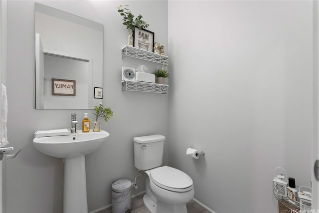 91-1669 Mee St, Ewa Beach, HI 96706 - bathroom featuring toilet, baseboards, and wood finished floors