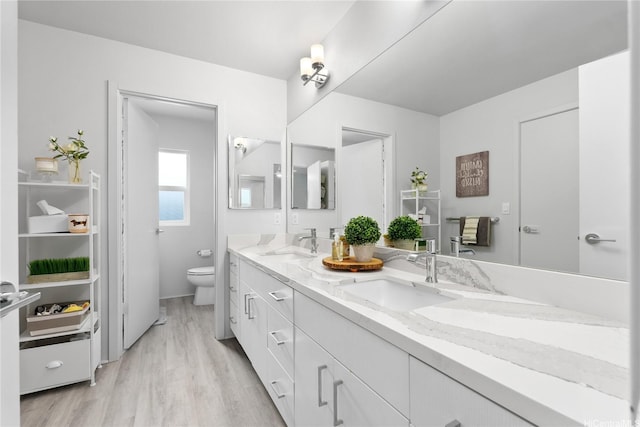 91-1669 Mee St, Ewa Beach, HI 96706 - bathroom with double vanity, toilet, and wood finished floors