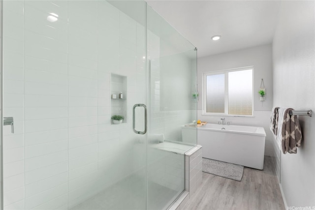 91-1669 Mee St, Ewa Beach, HI 96706 - bathroom featuring wood finished floors, a freestanding tub, and a shower stall