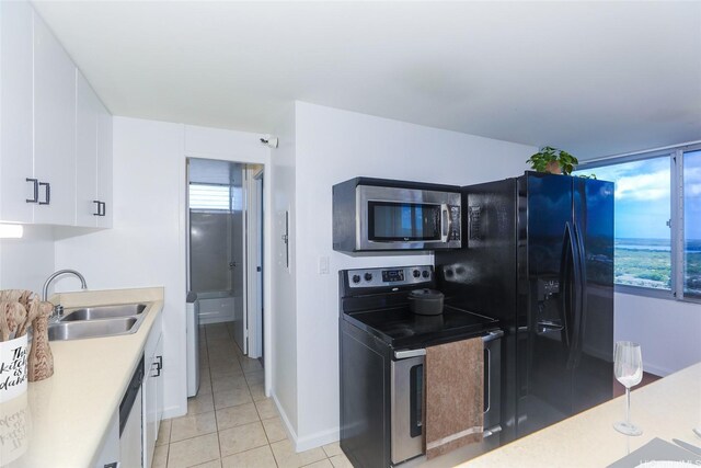 1060 Kamehameha Hwy Unit 2303A, Pearl City, HI 96782 - kitchen featuring stainless steel appliances, a sink, white cabinetry, light tile patterned floors, and light countertops