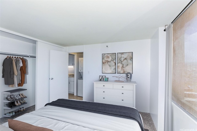 1060 Kamehameha Hwy Unit 2303A, Pearl City, HI 96782 - bedroom featuring stacked washer and clothes dryer and a closet