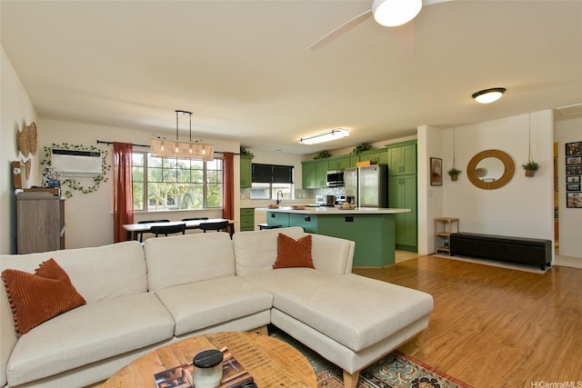 91-1175 Kaiau Ave Unit 903, Kapolei, HI 96707 - living area featuring light wood-style flooring, an AC wall unit, and a ceiling fan