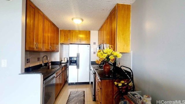 3161 Ala Ilima St Unit 2112, Honolulu, HI 96818 - kitchen with stainless steel appliances, a sink, brown cabinets, and a textured ceiling