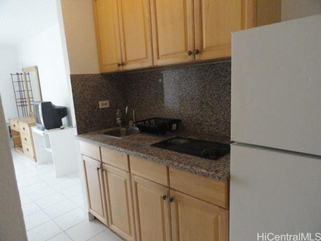 1920 Ala Moana Blvd Unit 1906, Honolulu, HI 96815 - kitchen featuring freestanding refrigerator, black electric stovetop, a sink, backsplash, and light tile patterned floors