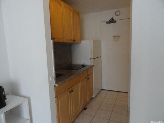 1920 Ala Moana Blvd Unit 1906, Honolulu, HI 96815 - kitchen featuring decorative backsplash, light tile patterned floors, freestanding refrigerator, and black electric stovetop