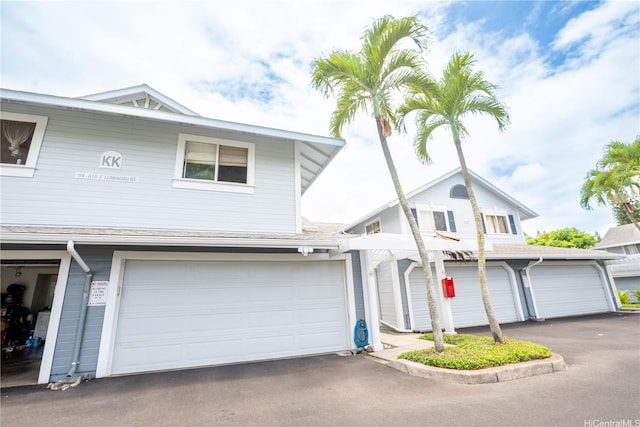 94-816 Lumiauau St Unit Kk102, Waipahu, HI 96797 - view of front of home with an attached garage and driveway