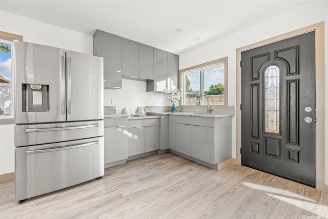 1528 Hooli Cir, Pearl City, HI 96782 - kitchen with stainless steel refrigerator with ice dispenser, gray cabinets, light wood finished floors, light countertops, and a sink