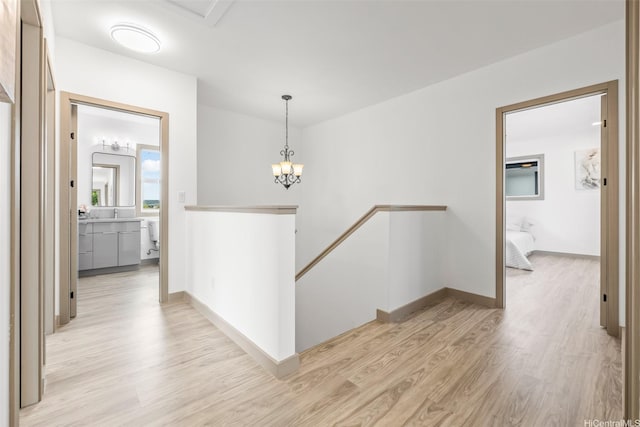 1528 Hooli Cir, Pearl City, HI 96782 - hallway featuring an upstairs landing, light wood-style floors, a chandelier, and baseboards