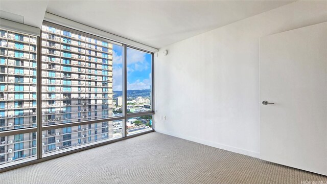 1001 Queen St Unit 2605, Honolulu, HI 96814 - unfurnished room with carpet flooring, a view of city, and expansive windows