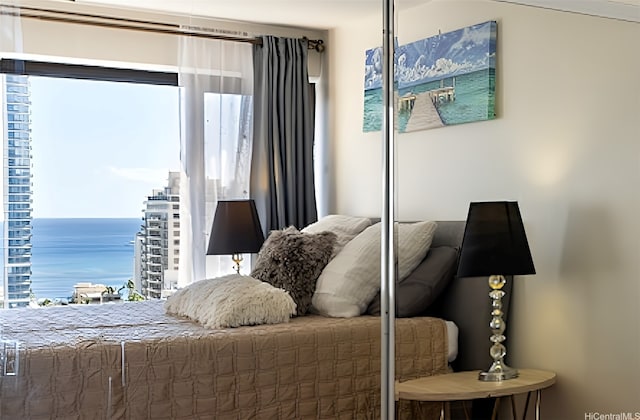 2140 Kuhio Ave Unit 1808, Honolulu, HI 96815 - bedroom featuring multiple windows and a water view