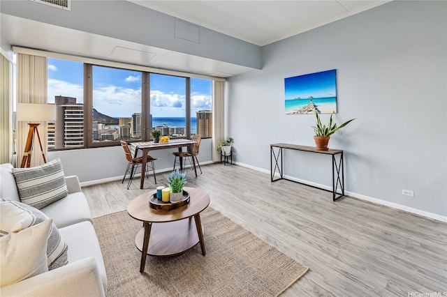 411 Hobron Ln Unit 3905, Honolulu, HI 96815 - living area with healthy amount of natural light, wood finished floors, baseboards, and a desk