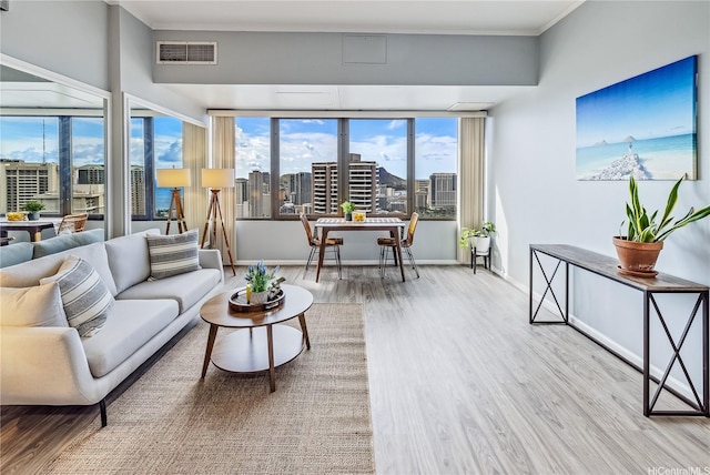411 Hobron Ln Unit 3905, Honolulu, HI 96815 - living room with wood finished floors, a view of city, plenty of natural light, baseboards, and ornamental molding