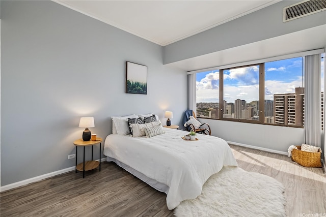 411 Hobron Ln Unit 3905, Honolulu, HI 96815 - bedroom featuring crown molding, wood finished floors, baseboards, and a city view