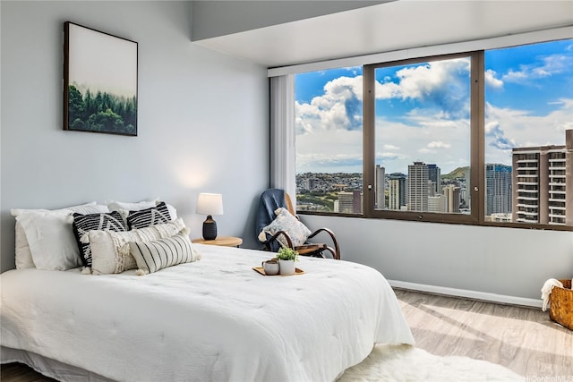411 Hobron Ln Unit 3905, Honolulu, HI 96815 - bedroom with wood finished floors, a city view, and baseboards