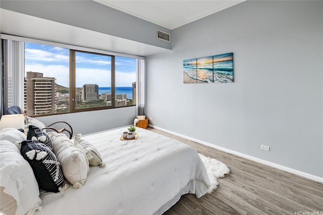 411 Hobron Ln Unit 3905, Honolulu, HI 96815 - bedroom with wood finished floors, crown molding, baseboards, and a water view