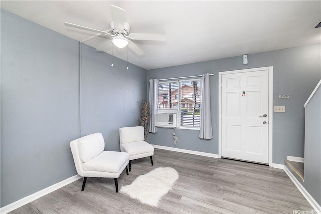 91-1167 Kamaaha Loop Unit 19F, Kapolei, HI 96707 - sitting room with wood finished floors, ceiling fan, baseboards, and cooling unit