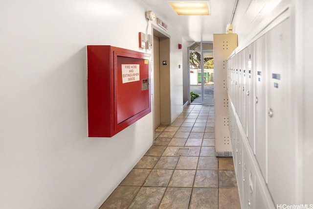 2488 Kapiolani Blvd Unit 203, Honolulu, HI 96826 - hallway with elevator and light stone finish flooring