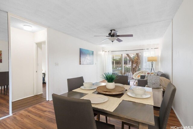 2488 Kapiolani Blvd Unit 203, Honolulu, HI 96826 - dining space featuring wood finished floors, a ceiling fan, and baseboards