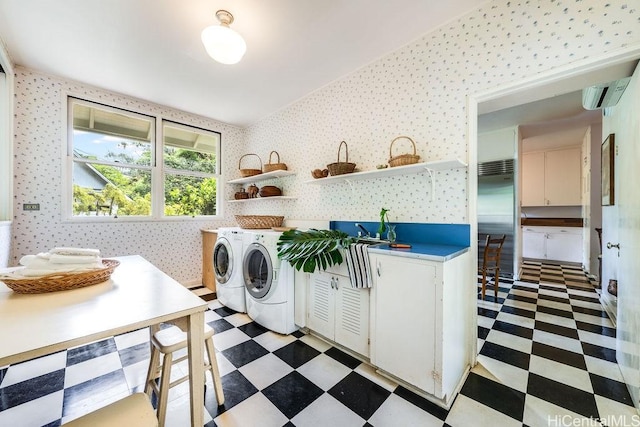 247 Dowsett Ave, Honolulu, HI 96817 - laundry room featuring cabinet space, washer and clothes dryer, wallpapered walls, light flooring, and a wall mounted AC