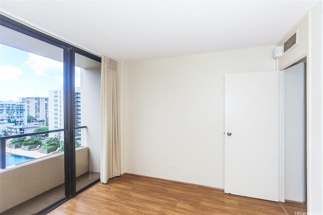 1717 Mott Smith Dr Unit 707, Honolulu, HI 96822 - spare room with light wood-style floors and a view of city