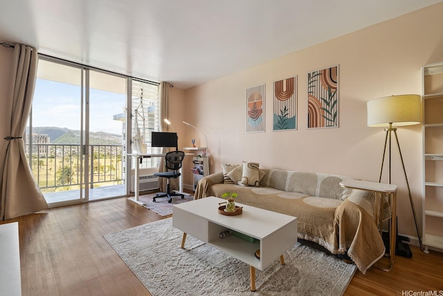 2452 Tusitala St Unit 1207, Honolulu, HI 96815 - living area with plenty of natural light, expansive windows, wood finished floors, and a desk