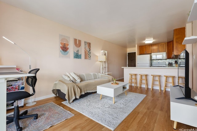 2452 Tusitala St Unit 1207, Honolulu, HI 96815 - living room with light wood-style flooring and baseboards