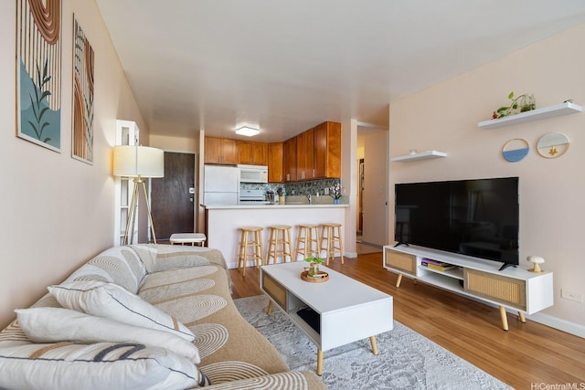 2452 Tusitala St Unit 1207, Honolulu, HI 96815 - living area with light wood-type flooring and baseboards