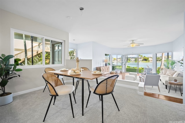 7007 Hawaii Kai Dr Unit A16, Honolulu, HI 96825 - dining area featuring a water view, healthy amount of natural light, baseboards, and carpet floors