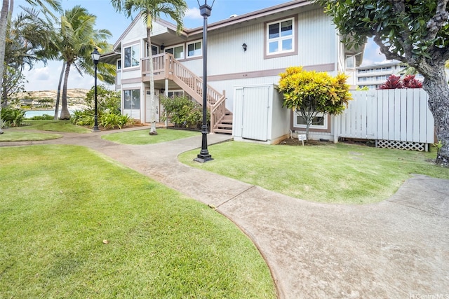 7007 Hawaii Kai Dr Unit A16, Honolulu, HI 96825 - back of house featuring stairs, a lawn, and a water view