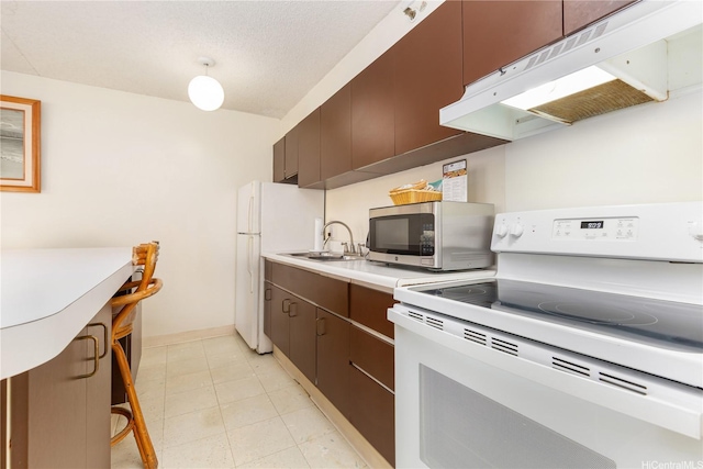 201 Ohua Ave Unit 1012Tower-I, Honolulu, HI 96815 - kitchen with white appliances, under cabinet range hood, a sink, light countertops, and baseboards