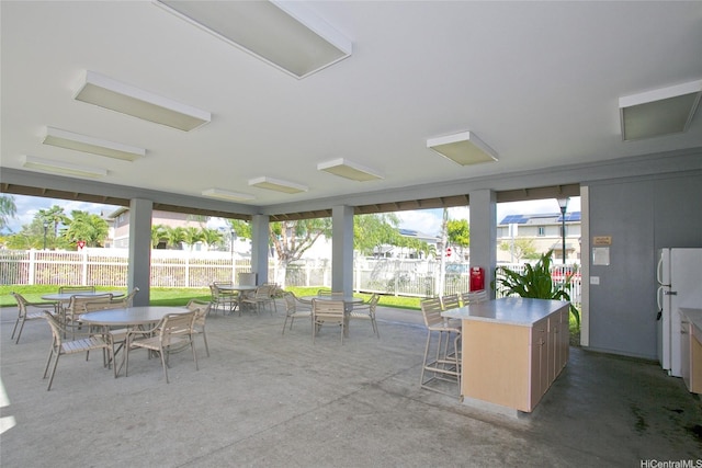 91-1200 Keaunui Dr Unit 400, Ewa Beach, HI 96706 - sunroom with outdoor dining space and concrete floors