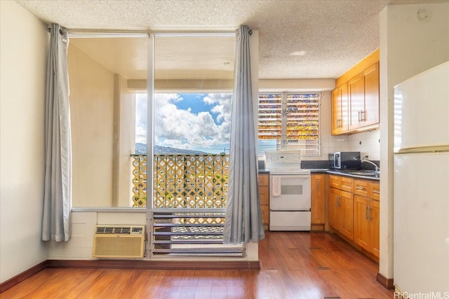 747 Amana St Unit 1405, Honolulu, HI 96814 - kitchen with white appliances, plenty of natural light, wood finished floors, and a textured ceiling