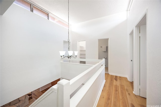 94-391 Kaholo St Unit 88, Mililani, HI 96789 - corridor featuring an upstairs landing, a chandelier, and light wood-style flooring