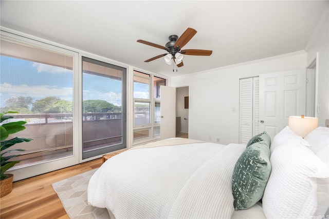 94-391 Kaholo St Unit 88, Mililani, HI 96789 - bedroom with ornamental molding, access to exterior, wood finished floors, a ceiling fan, and a closet