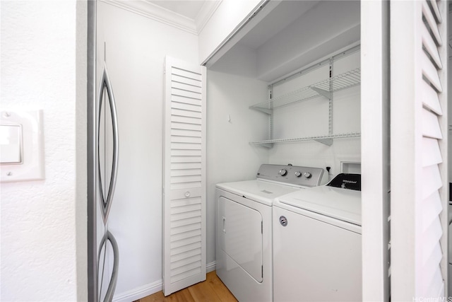94-391 Kaholo St Unit 88, Mililani, HI 96789 - laundry room featuring independent washer and dryer, ornamental molding, and light wood-style flooring