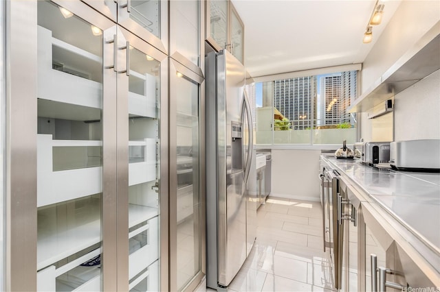2500 Kalakaua Ave Unit 504, Honolulu, HI 96815 - kitchen featuring stainless steel counters, baseboards, track lighting, and stainless steel dishwasher