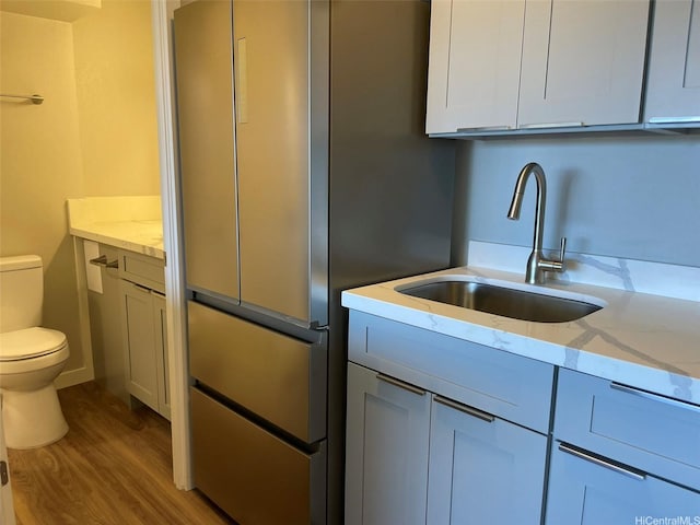 2888 Ala Ilima St Unit 910, Honolulu, HI 96818 - kitchen with a sink, light wood finished floors, light stone counters, and freestanding refrigerator