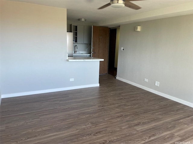 2888 Ala Ilima St Unit 910, Honolulu, HI 96818 - spare room featuring a ceiling fan, baseboards, dark wood-style floors, and a sink