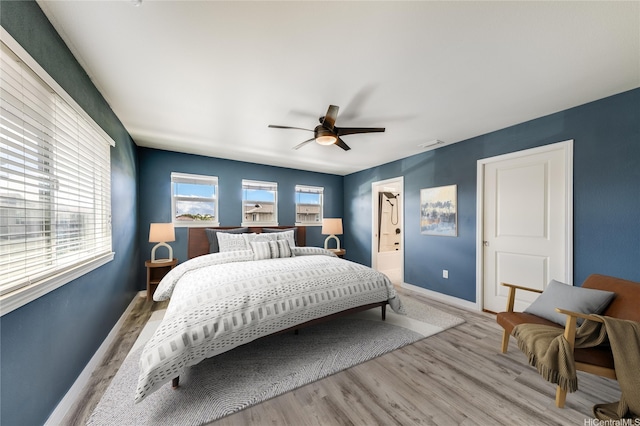 91-6221 Kapolei Pkwy Unit 334, Ewa Beach, HI 96706 - bedroom featuring light wood-type flooring, baseboards, ensuite bath, and ceiling fan