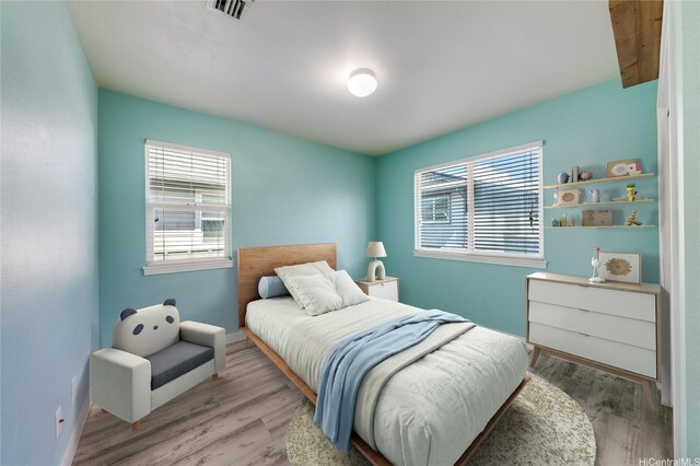 91-6221 Kapolei Pkwy Unit 334, Ewa Beach, HI 96706 - bedroom featuring multiple windows, wood finished floors, and baseboards