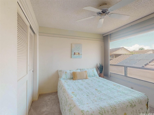 94-1036 Leomana Pl, Waipahu, HI 96797 - bedroom featuring light carpet, a closet, a ceiling fan, a textured ceiling, and baseboards