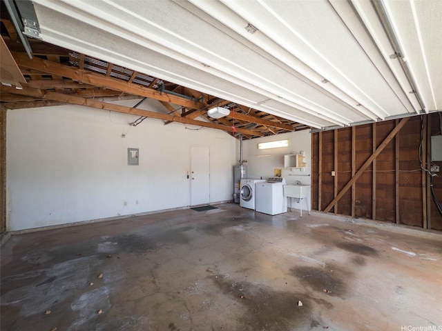 94-1036 Leomana Pl, Waipahu, HI 96797 - garage with washing machine and clothes dryer, a sink, electric panel, and gas water heater
