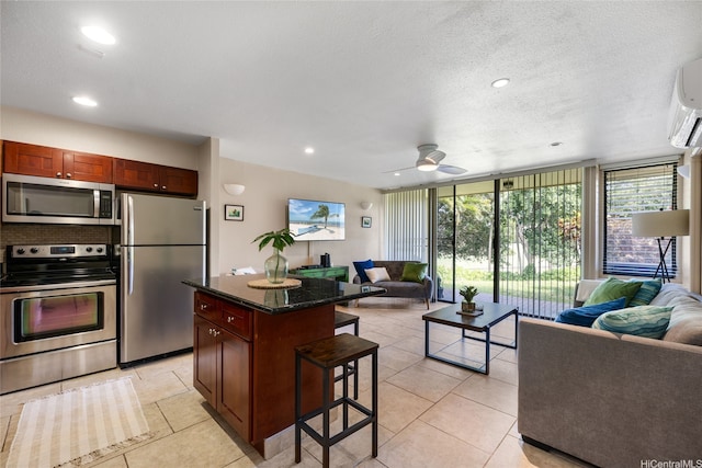 57-91 Lalo Kuilima Pl Unit 5/47, Kahuku, HI 96731 - kitchen featuring appliances with stainless steel finishes, open floor plan, a kitchen bar, ceiling fan, and recessed lighting